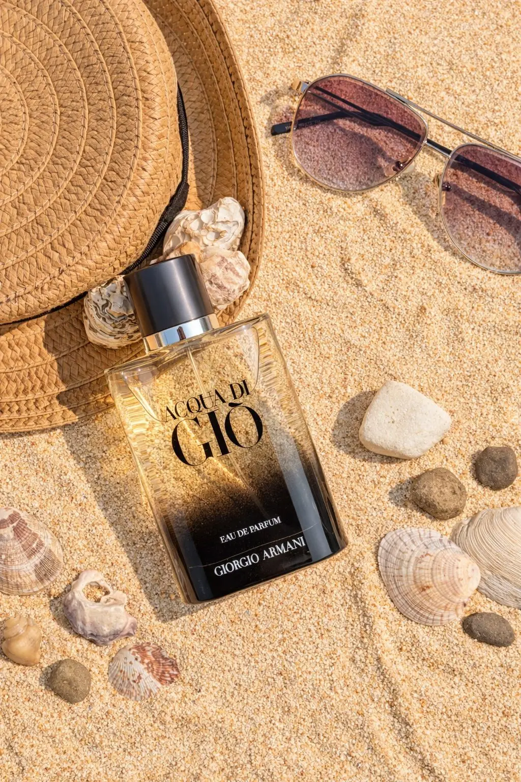 Giorgio Armani Acqua di Gio Eau de Parfum perfume bottle on sand background
